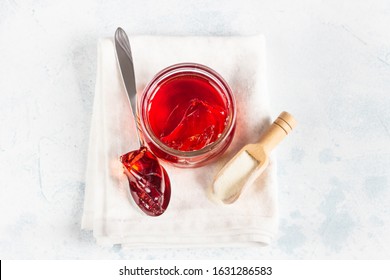 Homemade red berry gelatin dessert. Healthy dessert. Light grey stone background, selective focus. Copy space.
