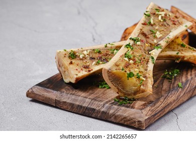 Homemade roasted beef bone marrow with garlic bread, closeup