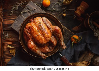 Homemade roasted chicken on a rustic wooden background. Close up. Top view