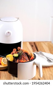 Homemade Roasted Whole Chicken With Lemon, Rosemary, Vegetable On Air Fryer. Copy Space For Text 