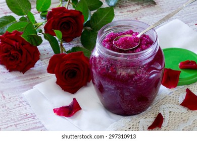 Homemade rose petal jam and sugar on a wooden table