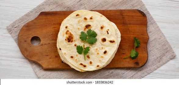 Homemade Roti Chapati Flatbread On A Rustic Wooden Board, Top View. Overhead, From Above, Flat Lay. 