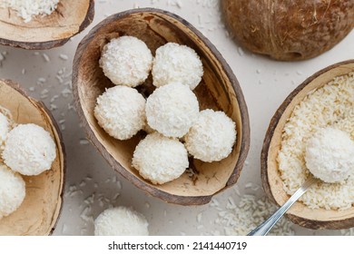 Homemade round candies made of coconut and white chocolate. Preparation of a delicious healthy dessert. Raffaello. Selective focus, top view - Powered by Shutterstock