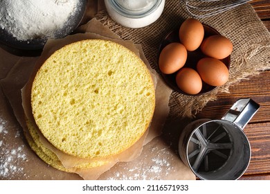 Homemade Round Sponge Cake Or Chiffon Cake On Table So Soft And Delicious With Ingredients: Eggs, Flour, Milk On Wood Table. Homemade Bakery Concept For Background And Wallpaper.