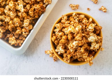 homemade salted caramel butter popcorn in yellow ceramic bowl on marble background. - Shutterstock ID 2230500111