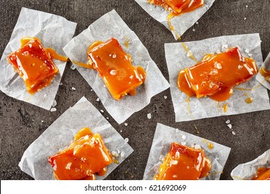 Homemade Salted Caramel Candies On Dark Grey Table, Top View