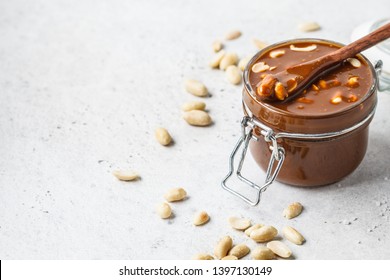 Homemade Salted Caramel With Nuts In A Glass Jar. Ingredient For Cake Snickers.