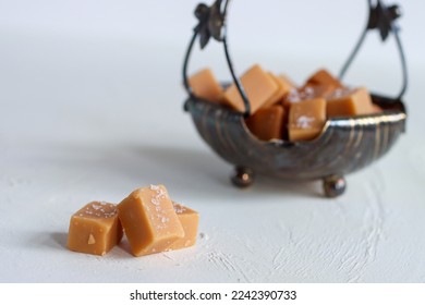 Homemade salty caramel pieces, delicious candy with salt - Shutterstock ID 2242390733