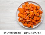 Homemade Sauteed Carrots on a plate, top view. Flat lay, overhead, from above. Space for text.