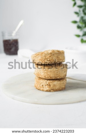 Homemade scones on a white marble tray, freshly baked yogurt scones, buttermilk scones on a white background