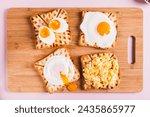 Homemade scrambled egg, poached egg, fried egg, boiled egg on toast on a board top view