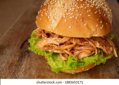 Homemade Shredded Chicken Sandwich On Rustic Wooden Board