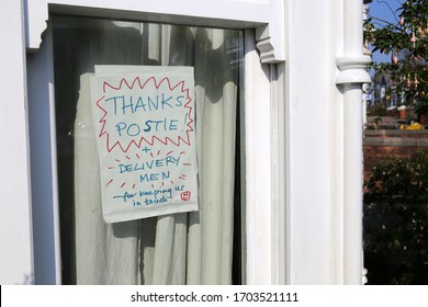 Homemade Sign In A House Window Thanking Postmen And Deliverymen During The Coronavirus Lockdown