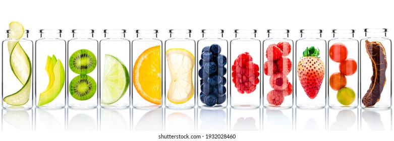 Homemade skin care with fruits ingredients avocado ,orange ,blueberry ,pomegranate ,kiwi ,lemon slice ,cucumber ,tamarind ,strawberry and raspberry in glass bottles isolated on white background.