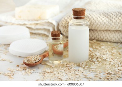 Homemade Skincare Cosmetic. Rice Water And Oat Flakes Facial Cleanser. Bottle Of Cereal Milk, Grains, Towels And Cotton Pads  