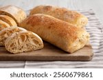 Homemade Sliced Ciabatta Bread on a wooden board, low angle view. Close-up.