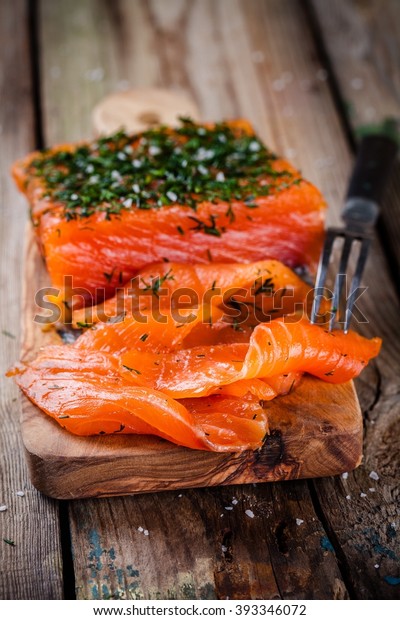 homemade smoked
salmon with dill on a wooden
table