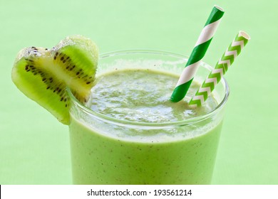 Homemade smoothie with fresh green fruits, wheat grass and herbs