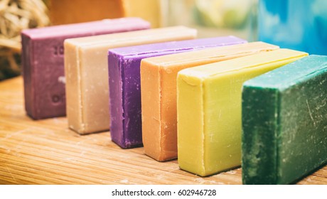 Homemade soaps. Variety of colorful handmade soap bars on wooden background