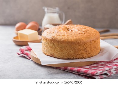 Homemade  Soft And Lite Delicious Sponge Cake With Ingredients: Eggs Flour Milk On Stone Concrete Table. Bakery Background Concept.