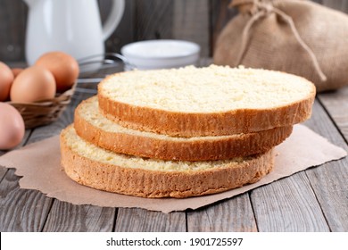 Homemade Soft And Lite Delicious Sponge Cake With Ingredients: Eggs, Flour, Milk On Wood Table. Bakery Background Concept.