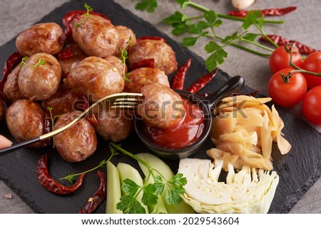 Homemade sour sausages with Thai herbs, vegetables. homemade pork meat sausages in skins with herbsand spices. Top view. Black background. Barbecue sausage with fresh parsley. grilled sausages.