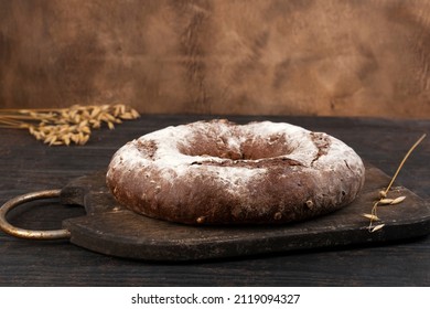 Homemade Sourdough Bread Loaf With Rye Flour And Rye Ears On The Background. Side View.