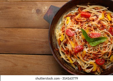 Homemade Spaghetti Bolognese on pan, on wooden background