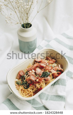 Homemade Spaghetti stir-fried on top with sausage, bacon, dry chilli and basil