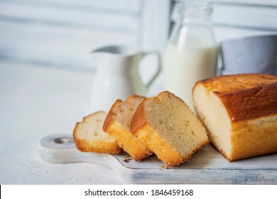 Homemade sponge cake or chiffon cake on white table, soft and moist dessert with milk. Homemade bakery concept for background, copy space, selective focus. Pound butter fluffy pie, white background.