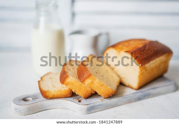 Homemade sponge cake or chiffon cake on white\
table, soft and moist dessert with milk. Homemade bakery concept\
for background, copy space, selective focus. Pound butter fluffy\
pie, white background.