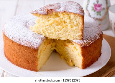 Homemade sponge cake on a white wooden table