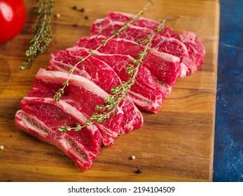 Homemade Steaks With A Sprig Of Rosemary On A Wooden Background. Minimalism. Home Cooking Recipes, Food Blog, Cookbook, Food Blog. There Are No People In The Photo.