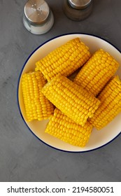 Homemade Steamed Corn On The Cob With Butter On A Plate, Top View. Flat Lay, Overhead, From Above.