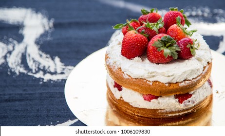 Homemade strawberry shortcake with gold plate and indigo print fabric