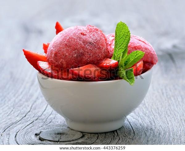 Homemade\
strawberry sorbet in a bowl on wooden\
table
