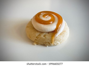 Homemade Sugar Cookie With Salted Caramel And Frosting Swirl On White Platter