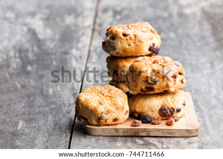 Homemade  sultana scones on wooden table 