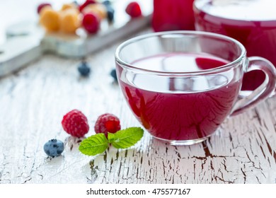 Homemade Summer Berry Tea With Rasberry, Blueberry And Mint On Rustic White Wooden Table