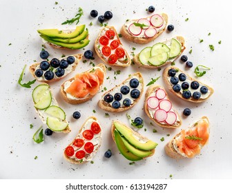 Homemade summer toast with cream cheese Smoked Salmon, Blueberries, Radish, Cucumber, Avocado and cress salad. Fresh healthy concept food.