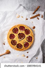 Homemade sweet figs cake, pie or tart with almond nuts on baking paper. Healthy vegan dessert. Top view.