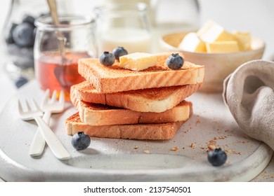 Homemade and sweet french toast with honey and fresh berries. Golden French Toast with butter and honey. - Shutterstock ID 2137540501