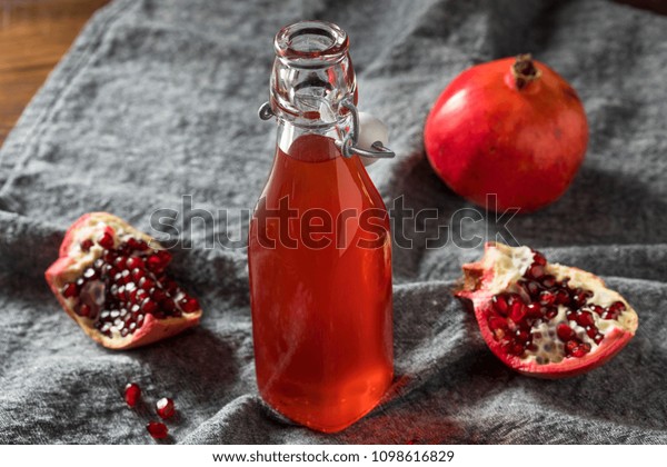 Homemade Sweet Red Pomegranate Grenadine Syrup in\
a Bottle