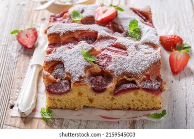 Homemade and sweet strawberry cake with fresh fruits and sugar. Homemade sponge cake.