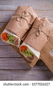 Homemade Tasty Burrito With Tuna Fish, Cucumber, Avocado And Carrot. Tuna Wraps On Wooden Background. Vertical, Overhead