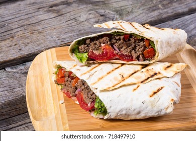 Homemade tasty burrito with vegetables and beef