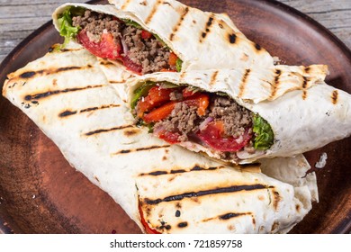 Homemade tasty burrito with vegetables and beef
