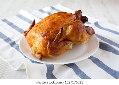 Homemade Tasty Rotisserie Chicken On White Plate, Side View. Close-up.