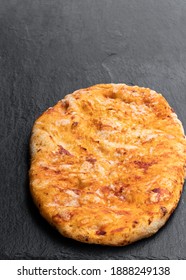 Homemade  Tomato And Garlic Flatbread On Stone Backgrouond 