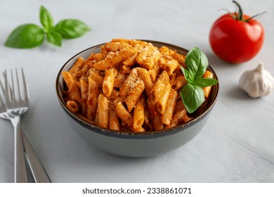 Homemade Tomato Pesto Pasta with Cheese and Basil in a Bowl, side view.  - Powered by Shutterstock